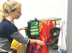 Jessica McDonald displays some of the costumes that are used for children&rsquo;s &ldquo;play therapy&rdquo; at Catholic Charities in Bloomington on May 31. (Photo by Katie Rutter)