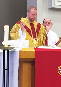 Father Kyle Rodden celebrates the Eucharist during a Mass at St.&nbsp;Monica Parish in Indianapolis, where he is associate pastor. (Photo by Natalie Hoefer)