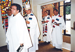 Then-Father-Charles Thompson processes in to celebrate his first Mass on May 30, 1987, at St.&nbsp;Bernard Church in Louisville, Ky. Pictured, from left, Father Joseph Fowler, the parish&rsquo;s pastor; then-Bishop Daniel M. Buechlein of Memphis, Tenn.; and Father Thompson. (Photo courtesy Father Dale Cieslik)