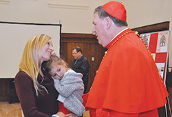 Young widow Jennifer Trapuzzano, 28, and her daughter Cecelia bid farewell to Cardinal Joseph W.&nbsp;Tobin on Dec. 5, 2016. She had turned to him earlier that fall about an idea she had for a Catholic&nbsp;widow&rsquo;s retreat, which has come to fruition and will be held at the Benedict Inn Retreat & Conference Center in Beech&nbsp;Grove on Sept. 22-24. (File photo by Natalie Hoefer)