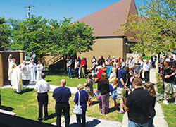 Members of St. Joseph Parish bow their heads in prayer during a blessing of the parish&rsquo;s Marian grotto as part of the parish&rsquo;s 150th anniversary celebration on June 25. (Parke County Sentinel photo by Lisa Wood)