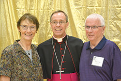Archbishop Charles C. Thompson smiles with Kathleen and Michael Dryer of St. Christopher Parish in Indianapolis at a reception at the Archbishop&nbsp;Edward T. O&rsquo;Mara Catholic Center after the Golden Jubilee Anniversary Mass at SS. Peter and Paul Cathedral in Indianapolis on Aug. 27. (Photo by Natalie Hoefer)