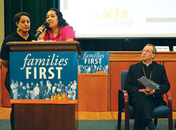 Maira Bordonabe, a member of St. Gabriel the Archangel Parish in Indianapolis and a married mother of two, shares her story of being taken for deportation as Archbishop Charles C. Thompson listens. Speaking in English before a crowd at an IndyCAN &ldquo;families first&rdquo; budget rally in Indianapolis on Aug.&nbsp;30, Bordonabe&rsquo;s story was translated into Spanish by Yuri Rodriguez, left. (Photo by Natalie Hoefer)