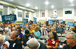 Those gathered for a rally promoting a &ldquo;families first&rdquo; 2018 federal budget hold signs during an IndyCAN gathering in the gymnasium of Holy Spirit Catholic School in Indianapolis on Aug. 30. (Photo by Natalie Hoefer)