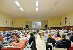 A record 380 people of the Miter Society watch a video about the United Catholic Appeal at the Archbishop Edward T. O&rsquo;Meara Catholic Center in Indianapolis on Oct. 10.