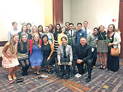 Father Rick Nagel, front row, right, poses with a group of young adults from his parish, St. John the Evangelist in Indianapolis, and students from Indiana University-Purdue University Indianapolis at the Right to Life of Indianapolis annual &ldquo;Celebrate Life Dinner&rdquo; on Oct. 3. (Submitted photo by Jacob Day)