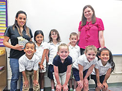 First-grade students in St. Ambrose School in Seymour are all smiles after raising more than $1,500 for classmate Gean Davila&rsquo;s family impacted by Hurricane Maria in Puerto Rico. Pictured in the front row, from left: Gean Davila, Lily Surface, Sloane Stephens and Isabella Fernandez. Back row: Gean&rsquo;s mother Belitzabeth Vazquez, Natalie Chavez, Calleigh Fugate, Sam Cutsinger and teacher Amy Hughes. (Submitted photo)