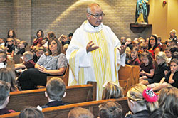 Father Thomas Clegg, pastor of St. John Paul II Parish in Sellersburg, preaches a homily during a Sept. 27 Mass with students of the New Albany Deanery faith community&rsquo;s school at St. Paul Church in Sellersburg. (Photo by Sean Gallagher)