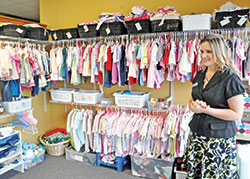 Kristi Potts, executive director of Pregnancy Care Center of Southeast Indiana in Lawrenceburg, discusses the agency&rsquo;s baby store of donated items, where young women can earn credit for the store by completing educational sessions. (Photo by Natalie Hoefer)