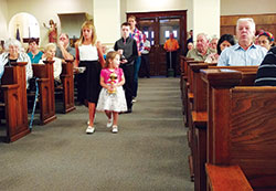 Olivia, left, and Katie Miller, front row, Wyatt McCain, second row, and Renee Tunny, all members of St.&nbsp;John the Baptist Parish in Osgood, bring up offertory gifts during a Sept. 10 Mass at the Batesville Deanery faith community&rsquo;s church to celebrate the 150th anniversary of its founding. (Submitted photo)