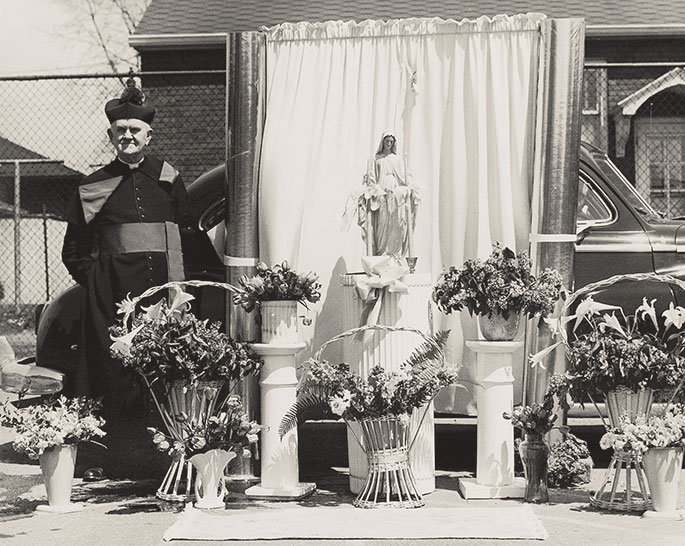 This photo shows a flag raising event at St. Mary School in North Vernon. Though no date is given on the photo, it could depict celebrations related to the dedication of the school building by Bishop Denis O&rsquo;Donoghue, former auxiliary bishop of Indianapolis, on June 21, 1908. St. Mary Parish was founded in 1861, and the school continues to operate in the building shown in this photograph.