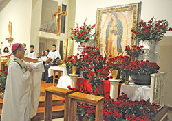 Archbishop Charles C. Thompson incenses an image of Our Lady of Guadalupe on Dec. 12 at St.&nbsp;Gabriel the Archangel Church in Indianapolis during a Mass on the feast of Our Lady of Guadalupe. (Photo by Sean Gallagher)