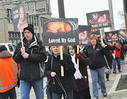 Participants pray the rosary as they walk along North Meridian Street in Indianapolis during the Jan.&nbsp;22, 2017, solemn observance of the legalization of abortion that occurred on Jan. 22, 1973. This year&rsquo;s inaugural Indiana March for Life, hosted by the archdiocese, the Diocese of Lafayette and Right to Life of Indianapolis, will be open to all and will process around the Statehouse in Indianapolis. (File photo by Natalie Hoefer)
