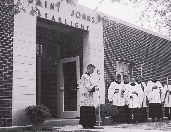 This photo shows a flag raising event at St. Mary School in North Vernon. Though no date is given on the photo, it could depict celebrations related to the dedication of the school building by Bishop Denis O&rsquo;Donoghue, former auxiliary bishop of Indianapolis, on June 21, 1908. St. Mary Parish was founded in 1861, and the school continues to operate in the building shown in this photograph.