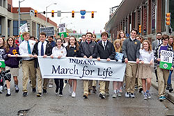 Students from Saint Theodore Gu&eacute;rin High School in Noblesville, Ind., in the Lafayette Diocese, lead a procession of approximately 500 participants along Capitol Avenue in Indianapolis on Jan. 22 for the inaugural Indiana March for Life, an event coordinated by the Archdiocese of Indianapolis, the Lafayette Diocese and Right to Life of Indianapolis. (Photo by Natalie Hoefer)