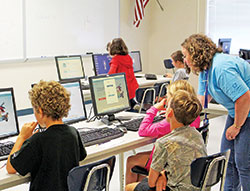 In this photo from June 28, 2016, Laura Swessel, a science teacher at Our Lady of Providence Jr./Sr. High School in Clarksville, works with fourth‑through sixth-graders participating in the school&rsquo;s summer STEM Camp, which is open to all students in the New Albany Deanery. (Submitted photo)