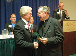 Archbishop Daniel M. Buechlein presents a Catholic Community Foundation (CCF) service award to St.&nbsp;Luke the Evangelist parishioner L. H. Bayley of Indianapolis, who previously served as president of the CCF board of trustees, during an annual meeting of the board on Oct. 24, 2007, in&nbsp;Indianapolis. (File photo by Sean Gallagher)
