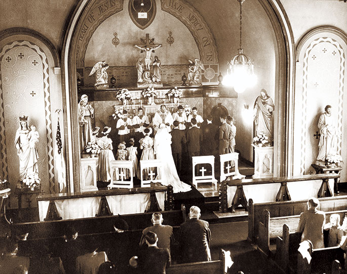 A wedding Mass is celebrated in 1950 at Most Precious Blood Church in New Middleton. Most Precious Blood Parish was founded in 1880. Its original church building burned down in 1927. A new church was constructed the following year and is still in use today. Most Precious Blood Parish is now part of the Tri‑Parish Catholic Community in Harrison County, which also includes St. Joseph Parish in Corydon and St. Peter Parish in Harrison County.