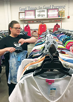 Connie Wright, a graduate of the Indianapolis St. Vincent de Paul Society&rsquo;s Changing Lives Forever program, restocks clothes on March 17 as part of her job at the charitable organization&rsquo;s Mission 27 Resale shop in Indianapolis. Funds raised by the store benefit the Changing Lives Forever program&mdash;which helps individuals learn how to pull themselves out of poverty&mdash;as well as the St. Vincent de Paul Food Pantry. (Photo by Natalie Hoefer)