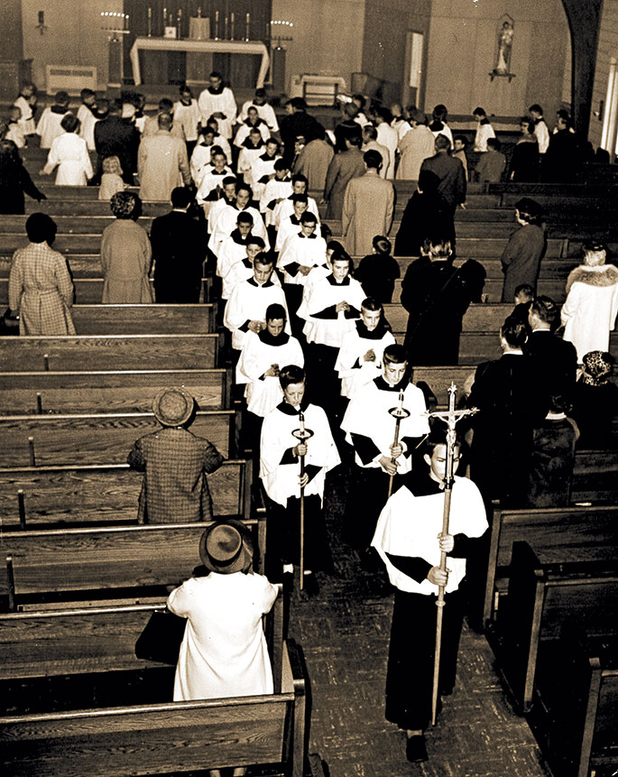 This photo was taken at the conclusion of an altar server investiture ceremony at St. Matthew the Apostle Church in Indianapolis on March 8, 1964. The new altar servers were in grades 5 through 8 in the Indianapolis North Deanery faith community’s school. Appearing nearest to the altar in the recessional line is St. Matthew’s pastor, Father Andrew Diezeman. The ceremony was sponsored by the Serra Club of Indianapolis, which works to foster priestly and religious vocations.