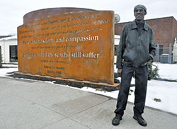 Abie Robinson, senior program coordinator for Indianapolis Parks and Recreation, stands on March&nbsp;26 before a new memorial in Kennedy King Park in Indianapolis. The memorial pays tribute to a speech given by Robert F. Kennedy in the park on April 4, 1968, the day Rev. Martin Luther King Jr., was assassinated. Robinson attended the speech. (Photo by Sean Gallagher)