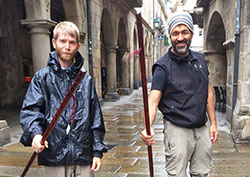 In a moment of celebration, Luke Hutchins, left, and Mark Peredo raise the walking sticks they purchased in Santiago de Compostela in northwestern Spain&mdash;walking sticks that serve as mementos of their memorable journey across the Camino. (Submitted photo)