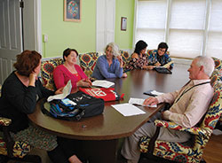 A Court Appointed Special Advocate (CASA) volunteer meeting takes place on April 3 in New Albany. Pictured are left, Debbie Mefford, director of St. Elizabeth Catholic Charities&rsquo; CASA program; volunteer Cheryl Schy; Kerma Hopewell, staff advocate/recruiter; and volunteers Donna Sherrard, Lynda Grunzinger and Paul Grunzinger. (Submitted photo)
