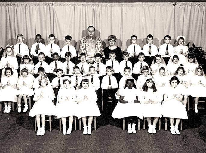 This photo depicts the first Communion class at St. Andrew the Apostle Parish School in Indianapolis in 1967. St. Andrew the Apostle Parish was founded in 1946, and the school was dedicated in 1948. Father Richard Mode, seen in the photo, served as pastor of the parish from 1966-1971. To view additional first communion photos, check out the weekly &ldquo;First Communion Friday&rdquo; feature on the archdiocesan archives Facebook page at: www.facebook.com/archindyarchives.
