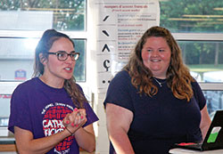 Julia Puscas, left, and Meghan Gehrich are young adult Catholics who love and live their Catholic faith. Here, Puscas introduces Gehrich, the youth ministry coordinator at St. Mary Parish in Greensburg, before she shared a faith-related talk with the teenagers who participated in the archdiocese&rsquo;s Homeland Mission program during the week of June 11-15. Puscas coordinated the program in which teenagers from across the archdiocese spend the week serving the poor and vulnerable in Indianapolis. Gehrich shared her talk in a classroom at Roncalli High School in Indianapolis. (Photo by John Shaughnessy)