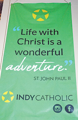 A banner captures one of the defining themes of the archdiocese&rsquo;s Office of Young Adult and College Campus Ministry. The website for the archdiocesan ministry for young adults is www.IndyCatholic.org. (Photo by John Shaughnessy)