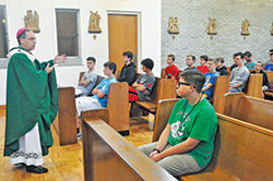 Teenage boys from across central and southern Indiana listen on June 27 to Archbishop Charles C. Thompson deliver a homily during a Mass that was part of the 13th annual Bishop Brut&eacute; Days at Bishop Simon Brut&eacute; College Seminary in Indianapolis. Sponsored by the archdiocesan Vocations Office, Bishop Brut&eacute; Days is a vocations camp for teenage boys open to the priesthood. (Photo by Sean Gallagher)