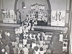 In this undated photo, children of St. Rose of Lima Parish in Franklin receive their first Communion in the parish&rsquo;s second church. (Submitted photo)