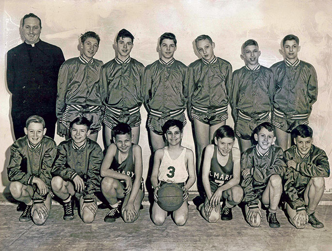 In this photo from 1948, the boys’ cadet basketball team from St. Mary Parish in New Albany celebrated their CYO tournament victory over the team from St. Peter Parish in Franklin County. The final score of the game was 25-17. The team is pictured with their coach, Father Donald Coakley, who was the associate pastor of St. Mary Parish from 1946-1950.