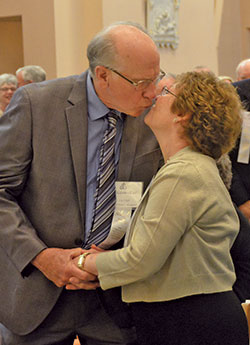 Malcolm and Charlene Ettel of St. Mary Parish in Lanesville share a kiss during the archdiocesan Golden Wedding Jubilee Mass at SS.&nbsp;Peter and Paul Cathedral in Indianapolis on Aug. 5. (Photo by Natalie Hoefer)