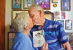 In their home in Waldron on Aug. 2, Carolyn and Omer Weintraut recreate the pose they struck on their wedding day on Aug.&nbsp;1, 1953. The members of St.&nbsp;Vincent&nbsp;de Paul Parish in Shelby County recently celebrated their 65th&nbsp;wedding anniversary. (Photo by Natalie Hoefer)