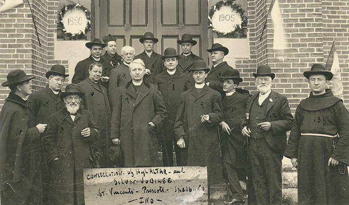 In 1905, St. Vincent de Paul Parish in Shelby County, which was founded in 1837, celebrated the silver jubilee of its church building, which was constructed in 1880. This photo from the occasion features several priests and two lay Catholics who gathered for the celebration. Father Joseph Bauer, who was pastor of the parish in 1905, appears at left in the front row. Standing in the first row, second from right, is Nicholas Weintraut, great-grandfather of Omer Weintraut, who is featured in an article that begins on page 1 of this issue. The church was destroyed by a fire on April 4, 1924. The cornerstone for a new church building was laid within the same year.