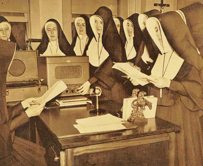 In this photo from August 1952, members of the Sisters of Providence of Saint Mary-of-the-Woods serving as grade school teachers attend a summer course in radio education and script writing at the order’s Saint Mary-of-the-Woods College. The course was created to meet the needs of sisters who had been asked, as part of their teaching assignments, to develop educational material for children to be broadcast on radio. This photo originally appeared in the Terre Haute TribuneStar.