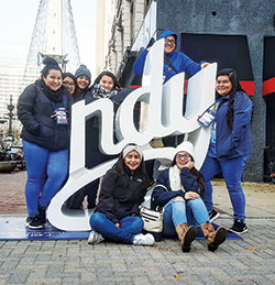Youths from Holy Spirit Parish in Indianapolis pose for a photo near Monument Circle during a break from the 2017 National Catholic Youth Conference in Indianapolis. In the front row are Narely Vasquez and Karen Rodriguez. In the back row are Behira Salgado, left, Yessica Cruz, Montse Rodriguez, Jaira&nbsp;Salgado, Isenia Rodriguez, and Suyen Salgado. (Submitted photo) 