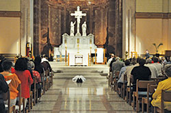 Worshippers kneel in prayer while Archbishop Charles C. Thompson lays prostrate on the floor of SS. Peter and Paul Cathedral in Indianapolis on Sept. 15 during a &ldquo;Holy Hour for Prayer, Penance and Healing&rdquo; for victims of sexual abuse. (Photos by Sean Gallagher)