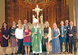 Archbishop Charles C. Thompson is pictured in SS. Peter and Paul Cathedral in Indianapolis on Sept.&nbsp;18 with archdiocesan staff and the winners of awards that were presented in the areas of Catholic education, catechesis, youth ministry and young adult ministry. Pictured, back row, left: archdiocesan superintendent of schools Gina Fleming; education honoree Lynne Locke; SS. Peter and Paul Cathedral rector Father Patrick Beidelman, who also serves as executive director of the Secretariat for Worship and Evangelization; archdiocesan director of catechesis Ken Ogorek; and director of the Secretariat of Pastoral Ministries Deacon Michael Braun. Front row, left: catechesis honorees Mary Jo Thomas-Day and Connie Powers; Archbishop Thompson; youth ministry honoree Julie Albertson; young adult ministry honoree Susan Grilliot; director of the archdiocese&rsquo;s Office of Young Adult and College Campus Ministry Matt Faley; and director of the archdiocese&rsquo;s Office of Youth Ministry Scott Williams. (Photo by John Shaughnessy)