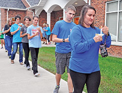 Members of St. Maurice Parish in Napoleon participate on Sept.&nbsp;22 in a candlelight procession to their faith community&rsquo;s church during a celebration of a year in which parish events were tied together by the theme &ldquo;Set Your Faith on Fire.&rdquo; The parishioners are, front, from right, Tara Ricke, Kevin Simon, Cloey Simon, Kayla Simon, Jenny Rickey and Dottie Hellmich. (Photo by Sean Gallagher)