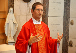 Father Eric Augenstein, archdiocesan vocations director, gives a homily during an Aug. 9, 2016, Mass at the chapel of Calvary&nbsp;Cemetery in Indianapolis during the annual archdiocesan seminarian convocation. As vocations director, Father Augenstein oversees the thorough evaluation process of potential seminarians for the archdiocese. (File photo by Sean Gallagher)