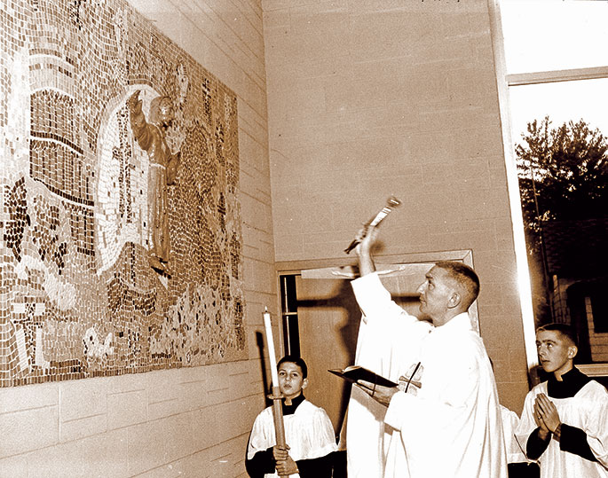 In this photo from Oct. 9, 1960, Father George Powers blesses a statue and mosaic of St. Leonard at the former St. Leonard of Port Maurice Church in West Terre Haute. The statue was blessed as part of a Forty Hours Devotion held at the parish beginning that day. St. Leonard of Port Maurice was a Franciscan who lived in Italy during the eighteenth century and fostered great devotion to the Stations of the Cross. The Terre Haute Deanery faith community was closed in 2011.