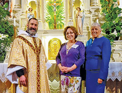 Father Aaron Pfaff, then-pastor of St. Joseph Parish in Shelbyville, poses with newly confirmed Catholic Edy Ballard, center, and her sponsor, Carol McElroy, in St. Joseph Church after the parish&rsquo;s Easter Vigil Mass on March 26, 2016. Returning to the Church after being away for 40 years, Edy Ballard of St. Joseph Parish in Shelbyville became involved in starting evangelization outreach efforts for her faith community. (Submitted photo)