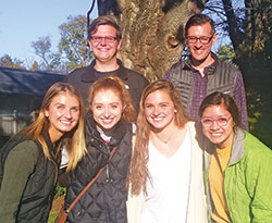 In Bloomington, a few of the Never Alone: Ministry to the Elderly (NAME) volunteers of St. Paul Catholic Center&rsquo;s campus ministry, serving the students of Indiana University, pose outside of the Golden LivingCenter where they visit the elderly once a week. The volunteers are, front row: Zoey Fields, left, Corinne Maue, Rileigh Johnson and Yahilin Vera; back row: Matthew Neuman, left, and Matthew Peisen. (Submitted photo)