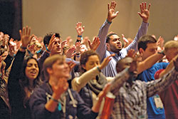 Young adults raise their hands in prayer during the Fellowship of Catholic University Students&rsquo; SEEK conference held on Jan. 3-7, 2017, in San Antonio, Texas. (Photo courtesy of Fellowship of Catholic University Students)
