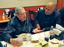 John Welch, left, and David Shaheed share a conversation during a lunch on Jan. 11 at Shapiro&rsquo;s Delicatessen in Indianapolis. In 1997, Welch, a longtime member of St. Joan of Arc Parish in Indianapolis and Focolare, a Catholic lay movement, started sharing lunch with members of the Nur‑Allah Islamic Center in Indianapolis, including Shaheed. Over the years, the lunch has grown to include other Focolare members and Protestant clergy. (Photo by Sean Gallagher)