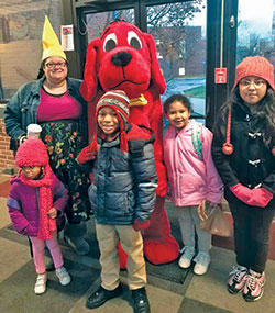 Showing her &lsquo;young at heart&rsquo; spirit, Sarah Jean Watson, principal of St. Lawrence School in Indianapolis, gets in on the fun with some of her students for a photo opportunity with Clifford the Big Red Dog. (Submitted photo)