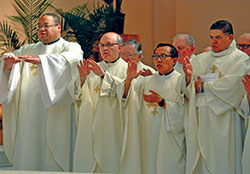 Fathers Douglas Hunter, left, Vincent Lampert, Minh Duong and Juan Jos&eacute; Vald&eacute;s join in the eucharistic prayer during the April 16 chrism Mass. (Photo by Sean Gallagher)