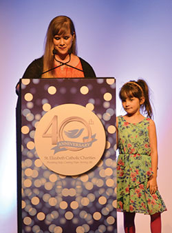 During the St. Elizabeth Catholic Charities &ldquo;Giving Hope, Changing Lives&rdquo; gala on April 25 in Louisville, Ky., Ariel LaGrange, left, shares the story of how the New Albany agency helped her and her daughter Ava Isabella, right. (Photos by Natalie Hoefer)